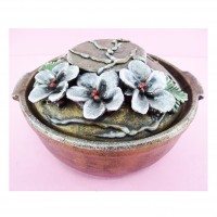 Brownish Colored Clay Pot With Colored Protruding Leaves And Flowers